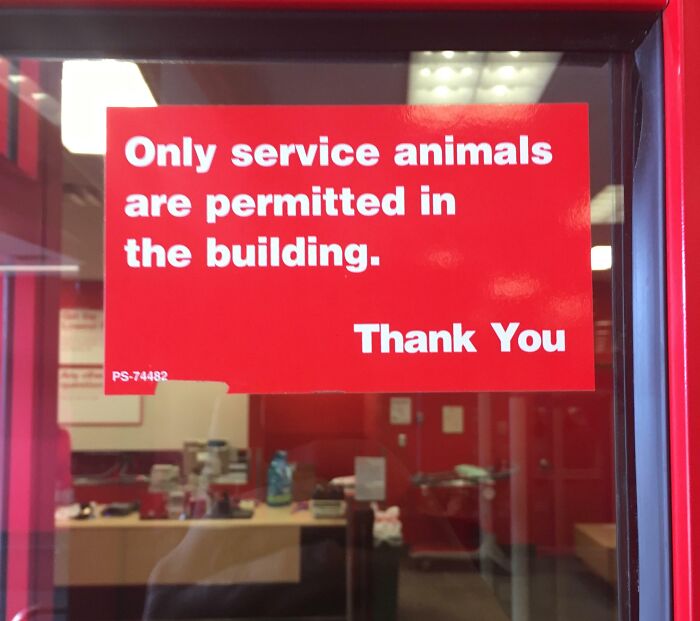 Red sign on glass door stating only service animals are allowed inside the building in unhinged pics of people following instructions.