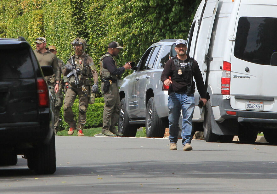 Law enforcement officers in tactical gear near vehicles capturing 2024 pop culture moments that shocked fans.