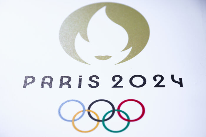 Paris 2024 Olympic logo featuring the iconic flame and Olympic rings, representing key 2024 pop culture moments.