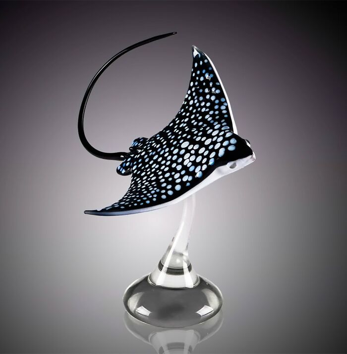 Glass sculpture of a spotted manta ray, showcasing stunning ocean life in intricate blown glass artistry.