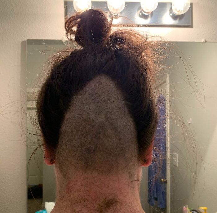 Back of a person's head showing a tragically uneven haircut, highlighting a funny and tragic hair accident.