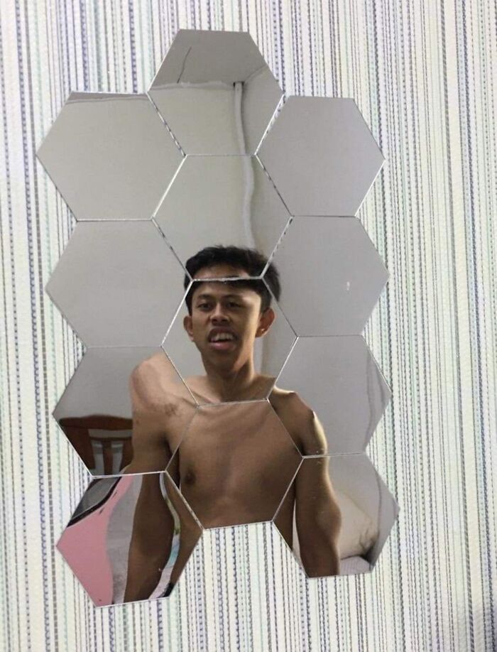 Hexagonal mirrored tiles reflecting a shirtless man, showcasing a creative and funny mirror reflection for selling.