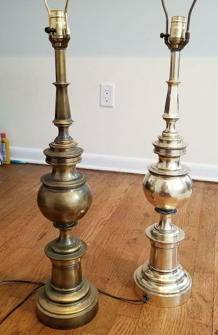 Before and after cleaning photo showing two brass lamps on a wooden floor with one polished and shiny and the other tarnished.