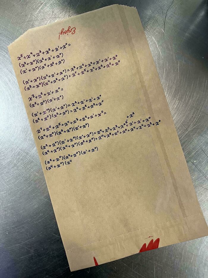 Brown paper bag with complex handwritten math equations on a metal surface, showcasing some things that cannot be explained.