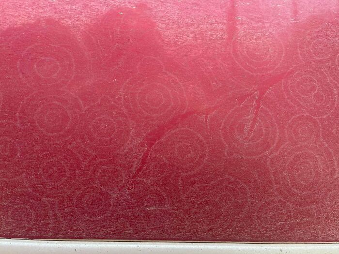 Red surface with unusual swirl patterns and faint markings, an example of unexplained phenomena in this interesting group.