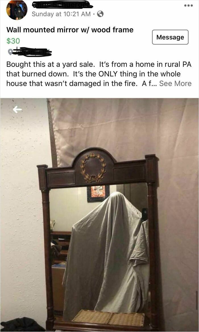Wall mounted mirror with wood frame showing a ghost-like reflection covered by a draped cloth humorously selling the reflection.