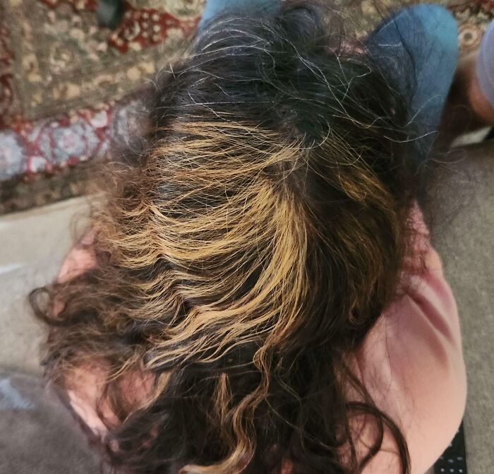 Top view of a person with tragically uneven and messy hair dye, highlighting a hilariously tragic hair accident.
