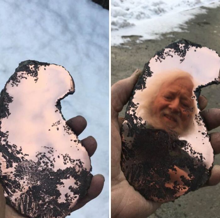 Hand holding a rusty, irregularly shaped mirror reflecting a man's face, showcasing funny mirror reflection moments.