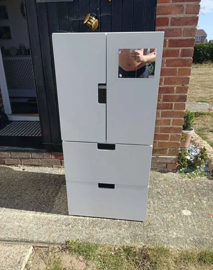 White cabinet with a small mirror reflecting a shirtless person, highlighting hilarious times people tried to sell a mirror.