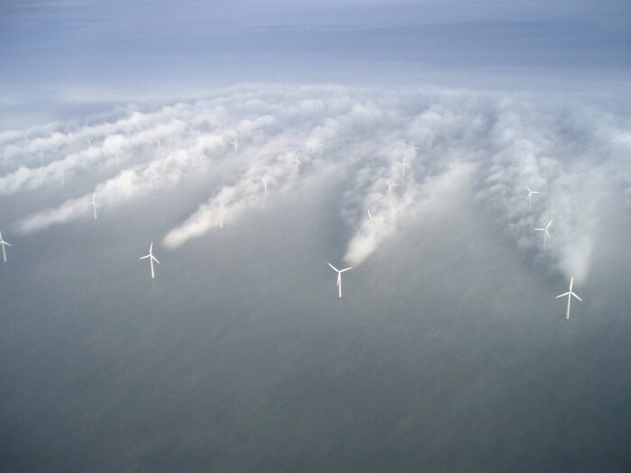 Wind turbines in fog creating visible airflow patterns, illustrating interesting pics that answer unexpected questions about nature.