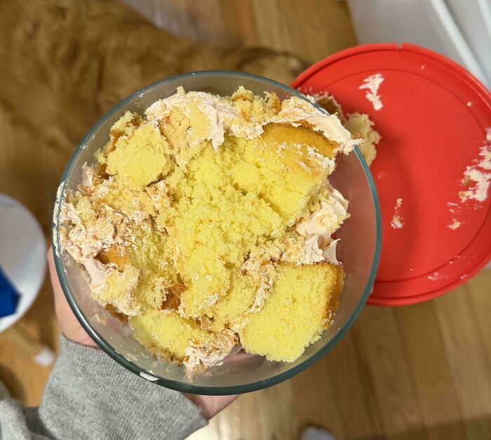 Bowl of crumbled yellow cake with frosting, illustrating a total mess in everyday life situations.