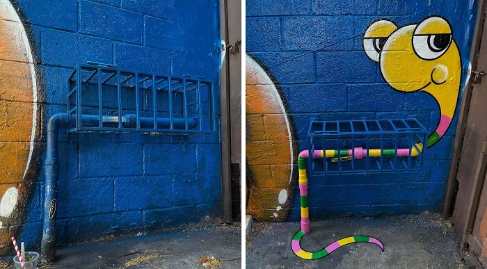 Urban whimsy street art by Tom Bob creatively transforms a parking rack pipe into a colorful snake on a blue brick wall.