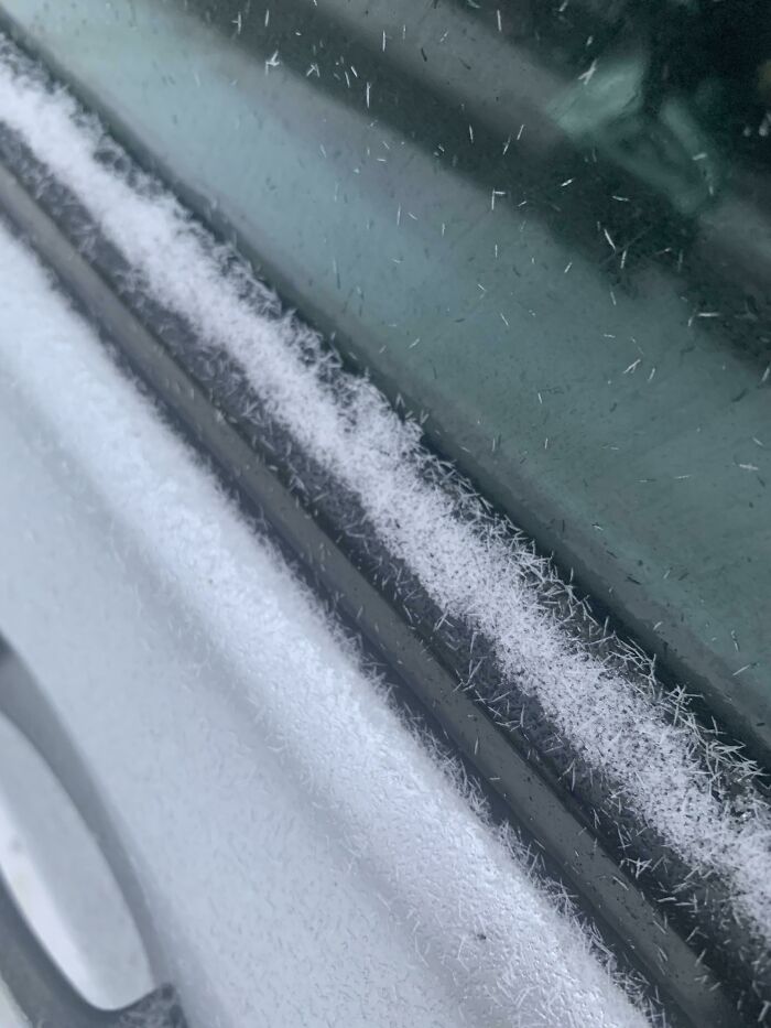 Close-up of car door edge with delicate frost crystals forming in cold weather, an interesting pic that answers curious questions.