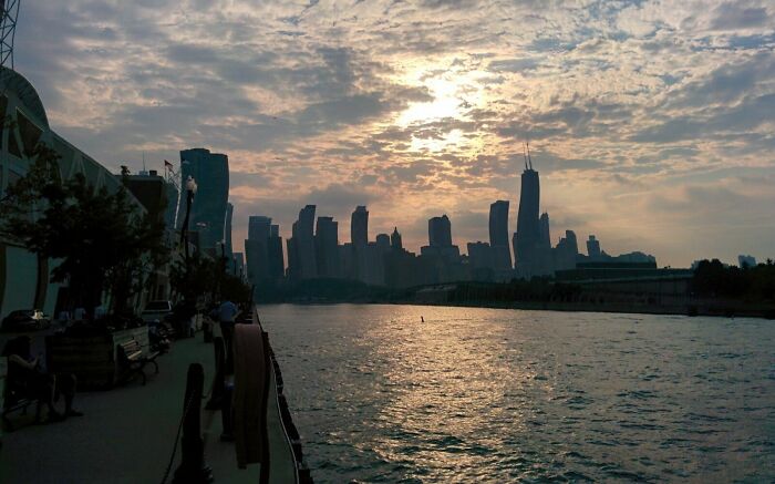 City skyline at sunset over a river, showcasing interesting pics that answer questions you didn’t know you needed to ask.