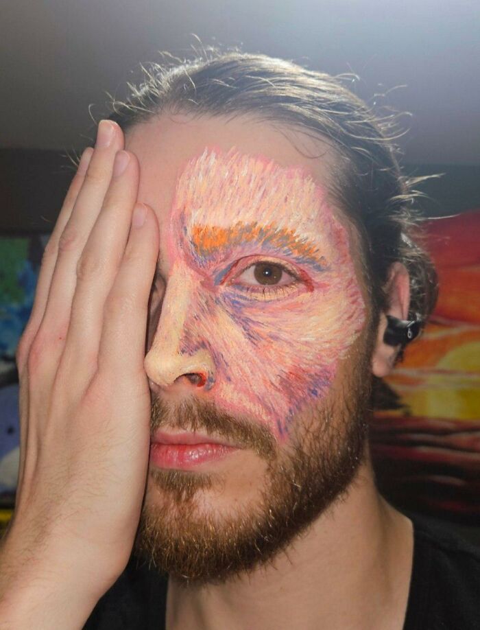 Artist with detailed Vincent van Gogh inspired face makeup showing textured brushstroke effects on half of his face.