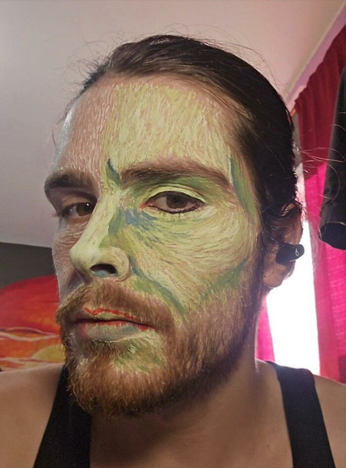 Artist with detailed Vincent van Gogh inspired makeup and hand-painted face, showcasing intricate brushstroke effects for Halloween.