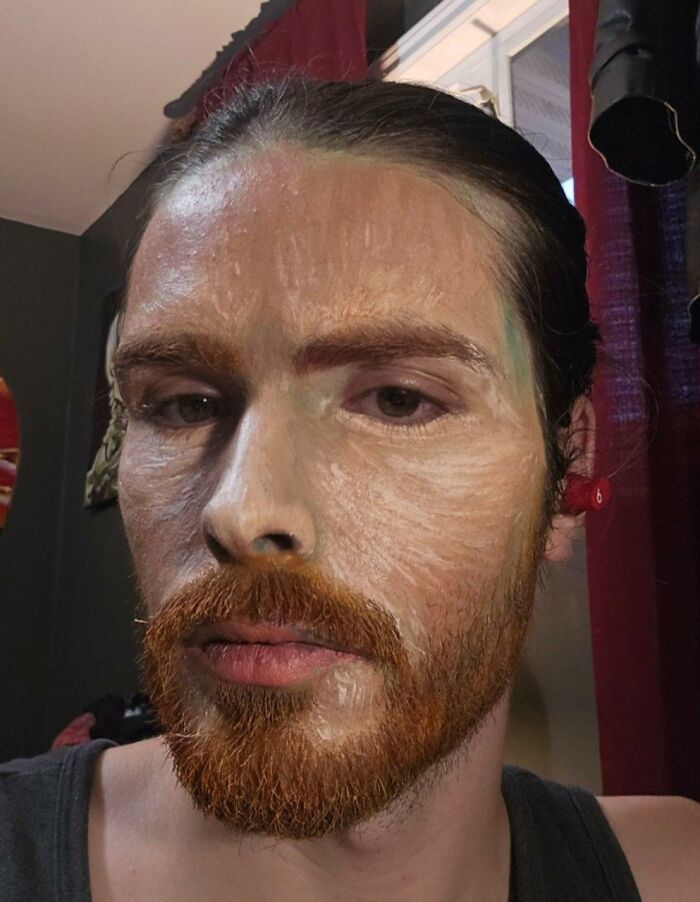 Artist with detailed face makeup and hand-painted costume transforming into Vincent van Gogh for Halloween.