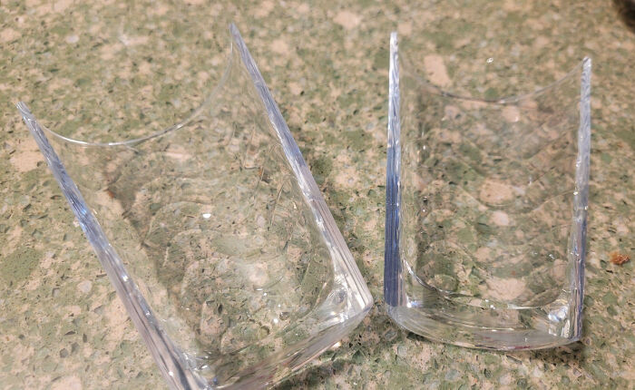 Two broken clear glass pieces resting on a speckled countertop, illustrating interesting pics that answer questions.