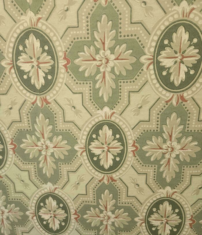 Vintage wallpaper pattern featuring floral and geometric shapes in muted green and beige tones, charming old homes style.