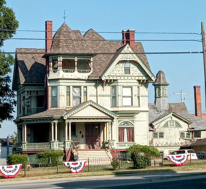 Victorian charming old home with intricate woodwork and a large porch, showcasing classic architectural details.