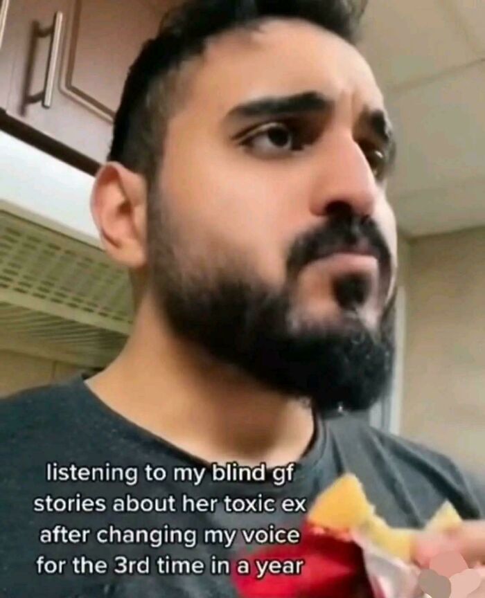 Man with a beard listening intently while eating snacks, reacting to posts that go from 0 to 100 real quick.