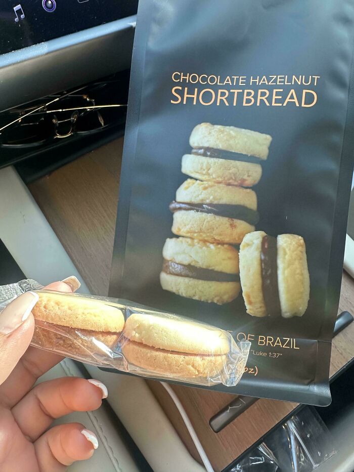 Misleading packaging showing large chocolate hazelnut shortbread on bag versus much smaller actual cookies in clear plastic wrap.