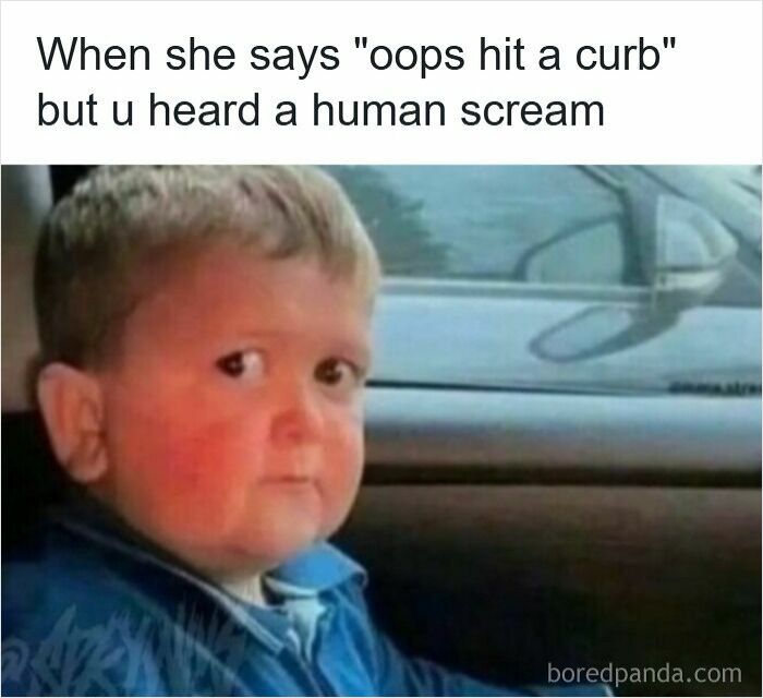 Child with a concerned expression in a car, illustrating relatable driving memes about road rage situations.