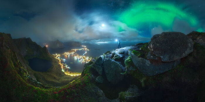 Panoramic landscape masterpiece showcasing northern lights and coastal village, a stunning Epson Pano Awards 2025 winning image.