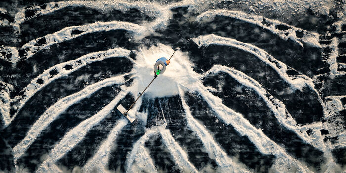 Aerial view of a person creating intricate snow patterns highlighting panoramic masterpieces from the Epson Pano Awards 2025.