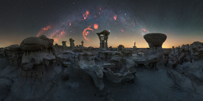 Panoramic masterpiece of rocky desert landscape under a starry night sky featuring glowing nebulae, Epson Pano Awards 2025.