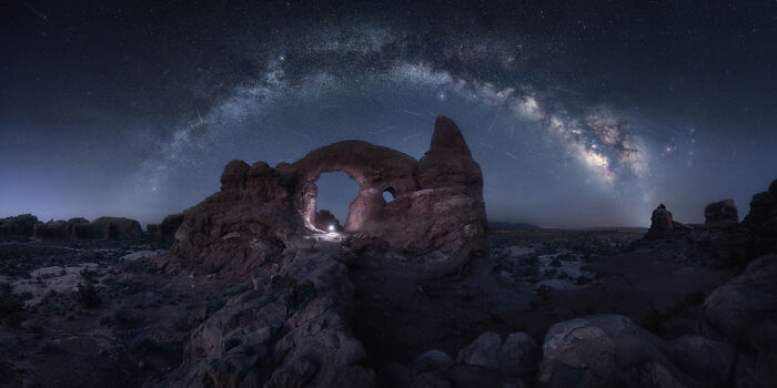 Panoramic masterpiece of a natural rock arch under a starry night sky showcasing the Epson Pano Awards 2025 quality.