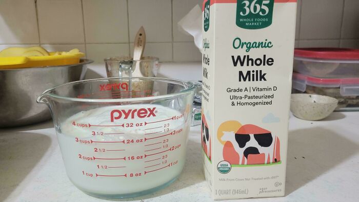 Misleading packaging showing organic whole milk carton next to a Pyrex measuring cup filled with milk.