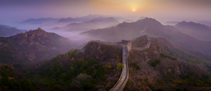 Panoramic masterpiece of the Great Wall at sunrise with misty mountains in the background, featuring winning Epson Pano Awards style.