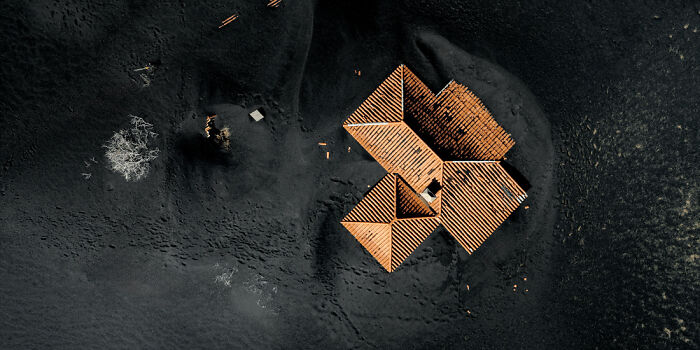 Aerial view of a rooftop structure surrounded by dark terrain capturing panoramic masterpieces winning the Epson Pano Awards.