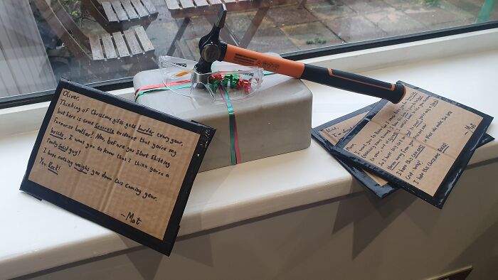 Hammer attached to a gift with notes showing petty revenge messages, illustrating examples of petty revenge tactics.