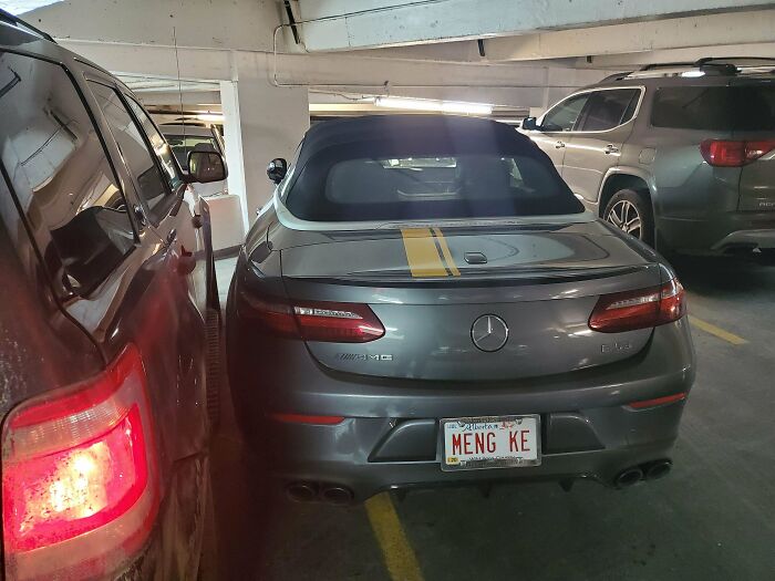 Luxury car parked over two spots in a garage, illustrating petty revenge and the consequences of being a jerk to others.