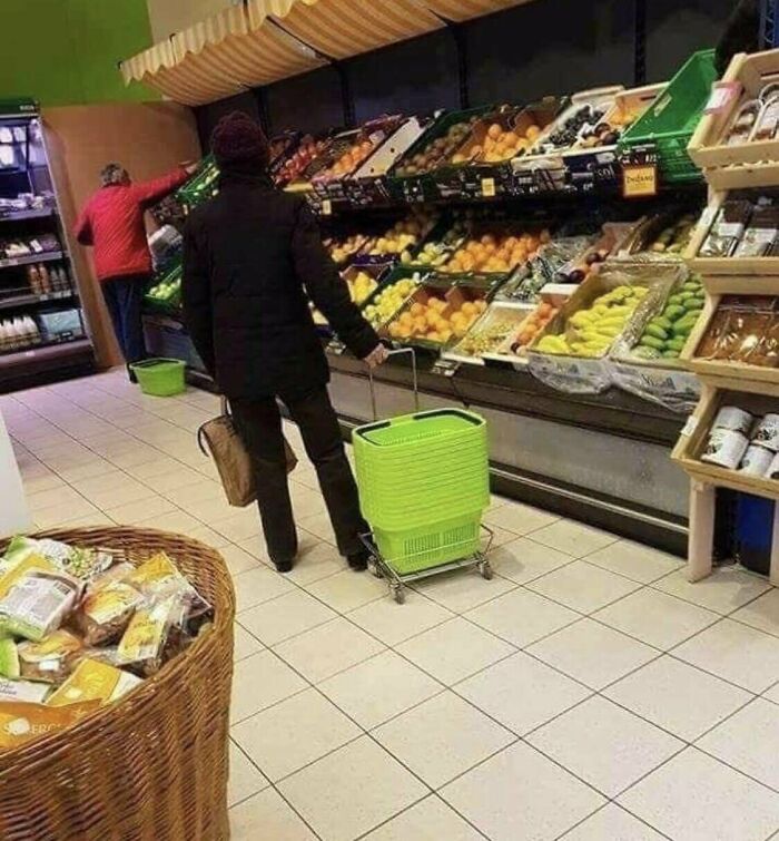 Person in a supermarket using a shopping basket on wheels, illustrating zero common sense in everyday situations.