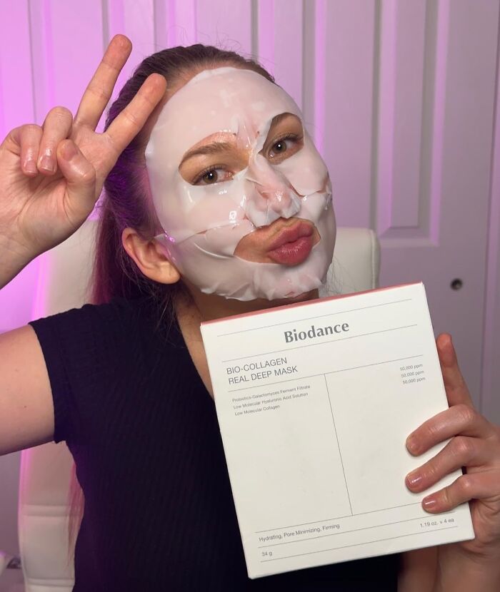 Woman wearing a bio-collagen face mask holding skincare product, one of the viral products bought during Amazon deal days.
