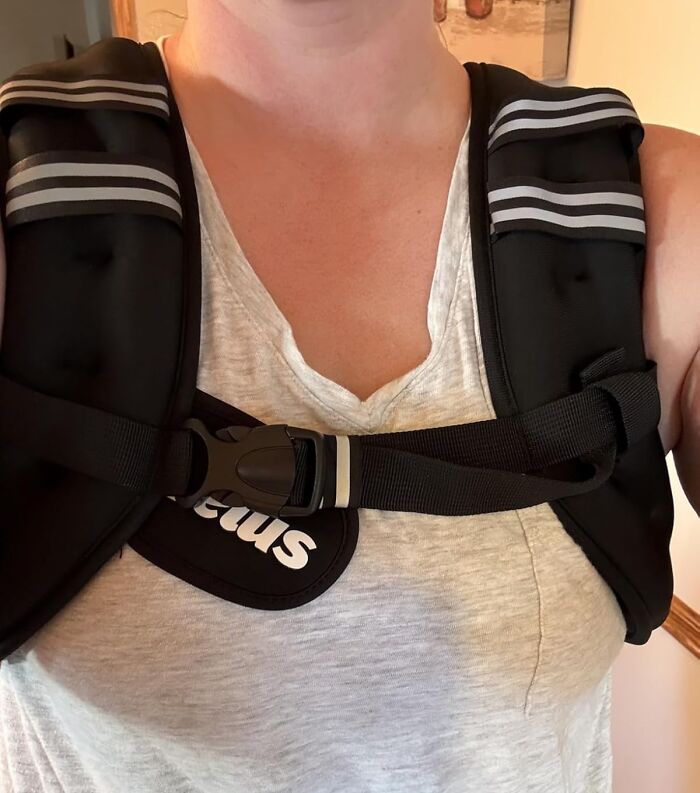 Person wearing a black weighted vest with adjustable straps, one of the viral products from Amazon's Big Deal Days.