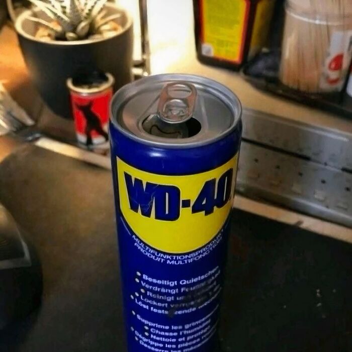 Opened WD-40 can on a kitchen counter appearing like a drink, fitting images that might need a priest or an exorcist.
