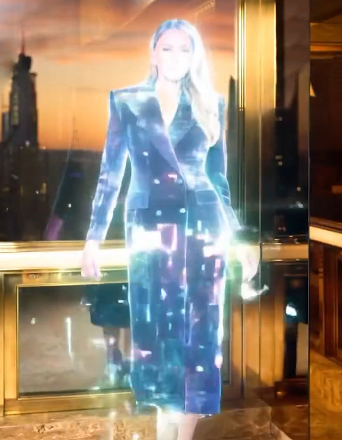 Melania Trump depicted in a glowing AI-generated video with a futuristic effect inside an elegant room.