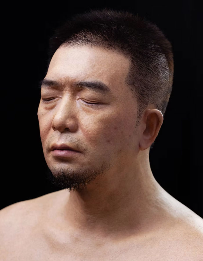 Hyper-realistic eerie new robot head with closed eyes, sparking debate about technology going too far in innovation.