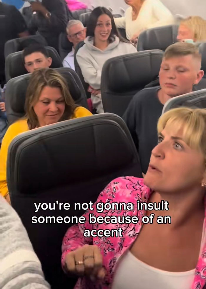 Woman in pink arguing on a plane, passengers reacting around her during Karen locking horns incident on flight. Woman in pink arguing on a plane, passengers reacting around her during Karen locking horns incident on flight.