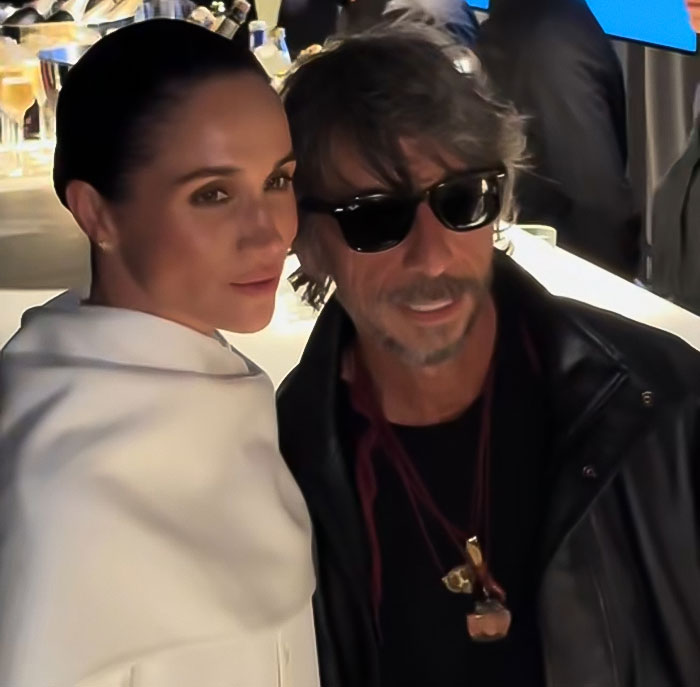 Meghan Markle posing with a man in sunglasses at Paris Fashion Week, featuring Balenciaga designer insights.