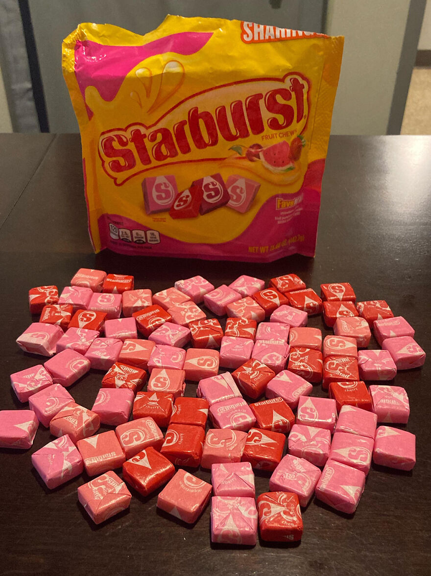 Starburst fruit chews spilled on table with package in background, popular Halloween candy ranked in 2025 reader’s vote