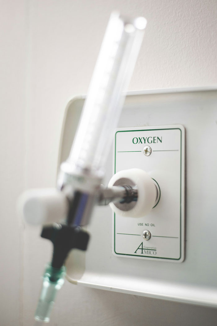 Close-up of an oxygen valve on a hospital wall illustrating scientific breathing research and medical oxygen delivery. Close-up of an oxygen valve on a hospital wall illustrating scientific breathing research and medical oxygen delivery.