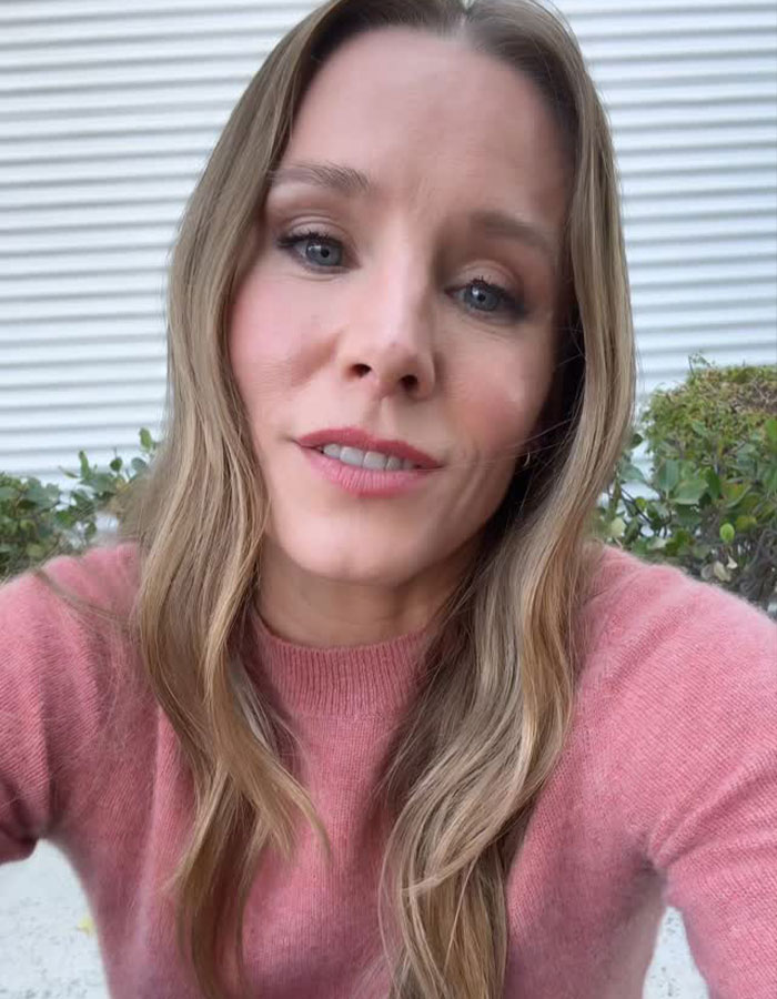 Kristen Bell wearing a pink sweater speaking outdoors about a tone-deaf anniversary post involving Dax Shepard. Kristen Bell wearing a pink sweater speaking outdoors about a tone-deaf anniversary post involving Dax Shepard.