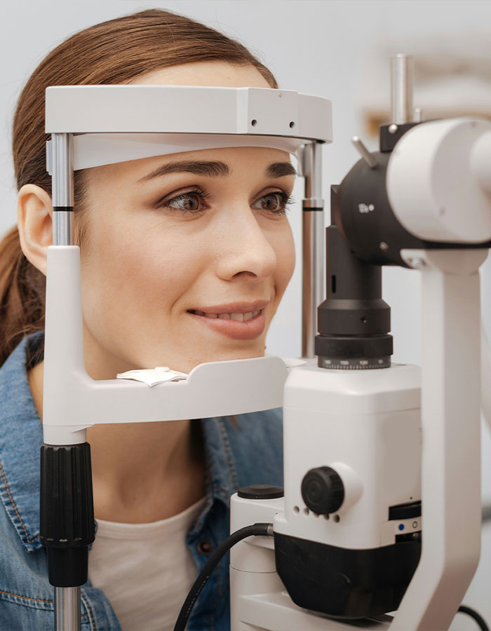 Woman undergoing an eye exam to assess risks of controversial eye color surgery and potential blindness complications.