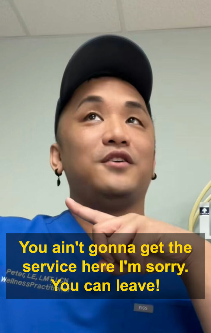 Aesthetician in blue scrubs and cap pointing while addressing a man during a viral interaction about a booking lie.