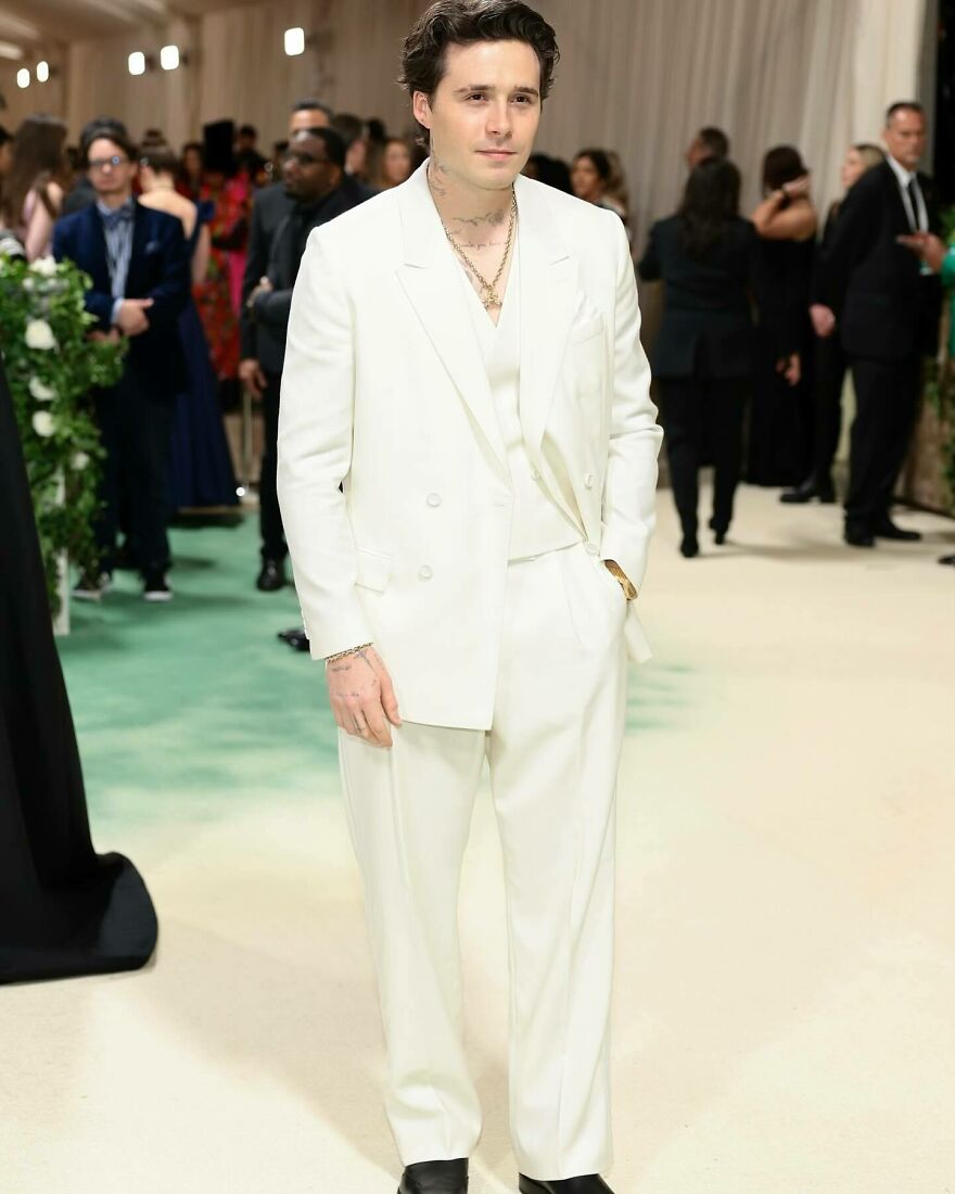 Brooklyn Beckham in a white suit at a formal event, representing one of the nepo babies defining Hollywood’s new generation.